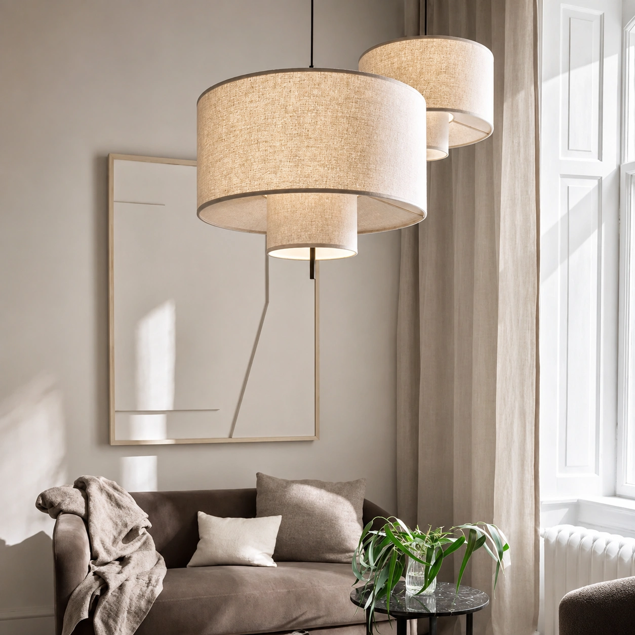 Layered linen drum pendant lights in a warm neutral modern living room